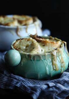 two bowls filled with food sitting on top of a blue cloth next to each other