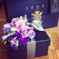 a purple box with flowers and a gold crown