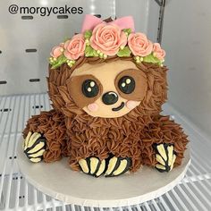 a cake decorated like a slotty bear with flowers on it's head and legs