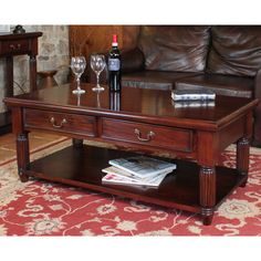 a coffee table with two wine glasses on it