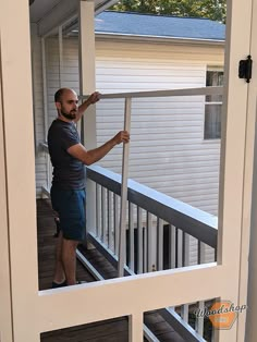 a man standing on a porch holding onto the railing