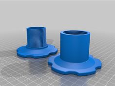 two blue plastic objects sitting next to each other on a gray surface with grids in the background