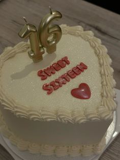 a heart shaped cake with the words sweet sixteen written on it and two hearts in the middle