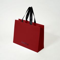 a red shopping bag with the word sample printed on it's front and side