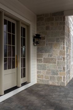 the front door is open to let in light on the house's exterior brick wall