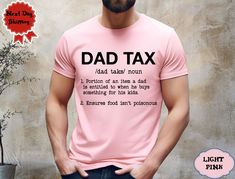 a man wearing a pink t - shirt with the words dad tax printed on it