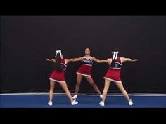 three cheerleaders performing on a tennis court