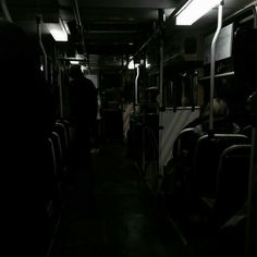 people are sitting on the bus in the dark