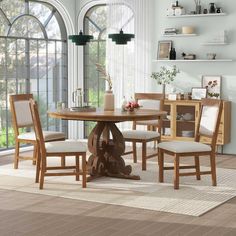 a dining room table with four chairs around it