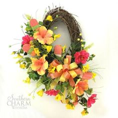 a wreath with orange and yellow flowers on it