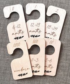 four wooden door hangers with numbers and arrows on them, one has the date for each