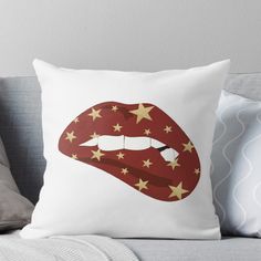 a red and gold lipstick with stars on it throw pillow by artfuldesigns