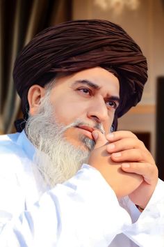 a man with a long white beard wearing a turban and holding his hand to his chin