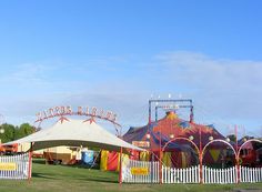 an amusement park with tents and carnival rides