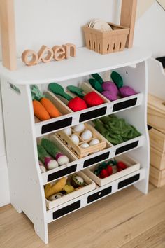 a white toy shelf filled with lots of toys