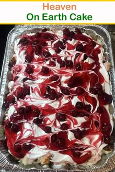 a cake covered in cherries and white frosting on top of a metal pan