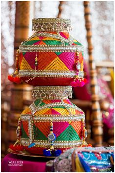 three colorfully decorated boxes stacked on top of each other