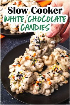 someone is holding up some white chocolate candies with sprinkles