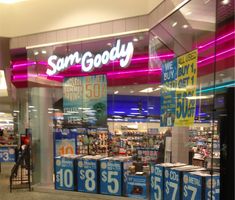 an empty store front with signs on the windows and in the middle of the aisle