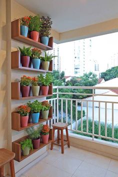 a balcony with potted plants on the wall