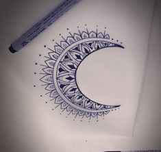 a drawing of a crescent moon on paper