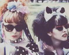 two women with sunglasses and bows on their heads