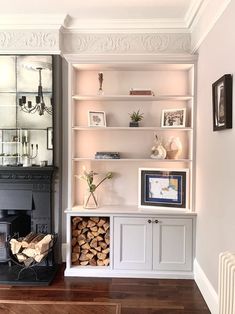 a living room filled with lots of furniture and bookshelves next to a fire place