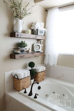 two baskets are sitting on the edge of a bathtub in front of a window