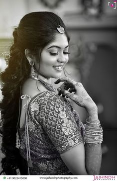 a woman in a sari is smiling and holding something