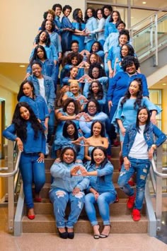 a group of women posing for a photo on some stairs