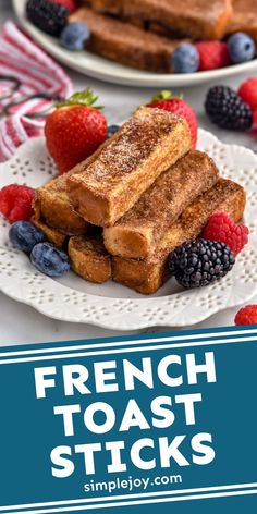 french toast sticks with berries and blueberries on the side, in front of another plate