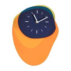 an orange and blue clock sitting on top of a table