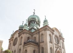 an old building with green domes on top