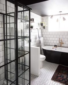 a black and white bathroom with a glass shower door