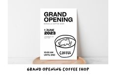 the grand opening coffee shop sign is displayed on a wooden stand with a cup of coffee