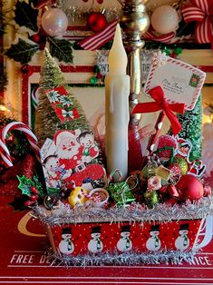 a candle is sitting in a basket with christmas decorations