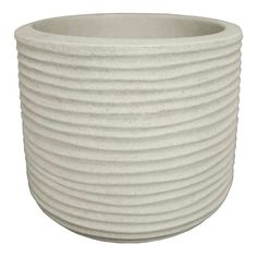 a large white vase with wavy lines on the outside and inside, sitting in front of a white background