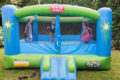 an inflatable bounce house with two children playing inside