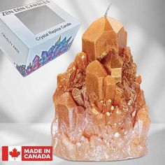 a candle that is sitting on top of a rock with rocks and crystals around it