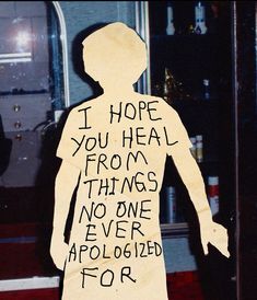 a paper cut out of a man with words written on his body and handwritten in black ink