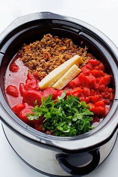 a crock pot filled with meat and vegetables