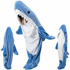 a woman in a shark costume standing next to two sharks