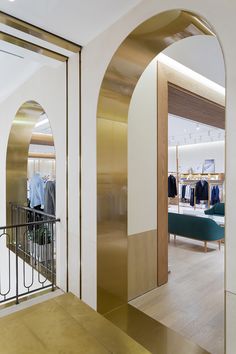 the interior of a clothing store with gold accents