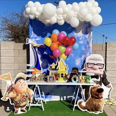 an outdoor party with balloons and decorations