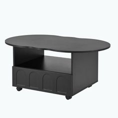 a black coffee table with wheels on the bottom and an open drawer underneath it, in front of a white background