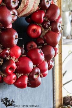 an apple wreath is hanging on the front door