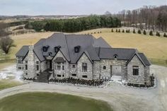 an aerial view of a large stone house