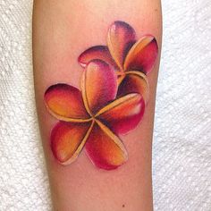 three different tattoos with flowers on them