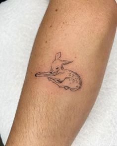 a small rabbit tattoo on the arm