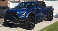 a blue truck parked in front of a house